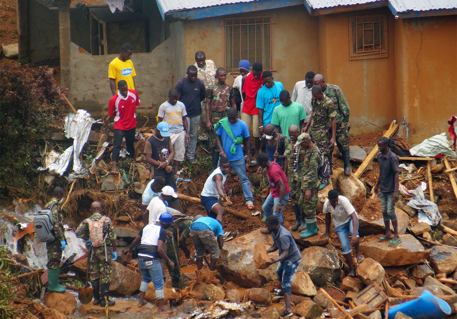 Vrijwilligers zoeken naar lichamen van de plaats van zware overstromingen en modderstromen in 2017, in Regent, net buiten de hoofdstad van Sierra Leone, Freetown. 