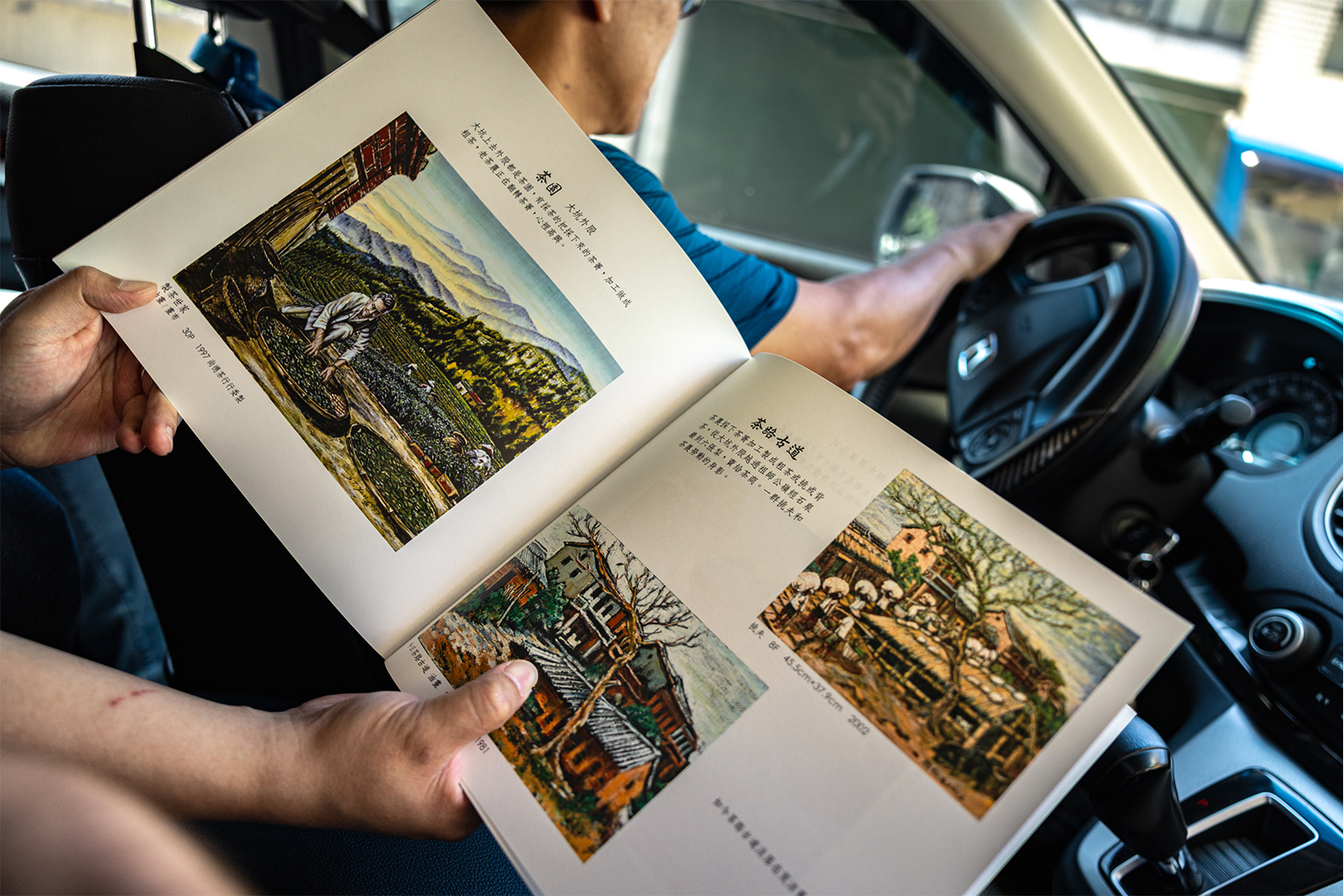 Chen-Lung Chien toont een boek van Song-Tao Yen, dat de vroegere welvaart van Old Street in het Shenkeng-district, Taiwan, illustreert. Shenkeng was oorspronkelijk een van de belangrijkste theeproductiegebieden in Azië, bekend om zijn Wenshan baozhong-thee, maar de industrie begon in de jaren zeventig terug te lopen als gevolg van industriële overdracht, verstedelijking en een vergrijzende bevolking. Afbeelding door Michael O. Snyder voor Mongabay.