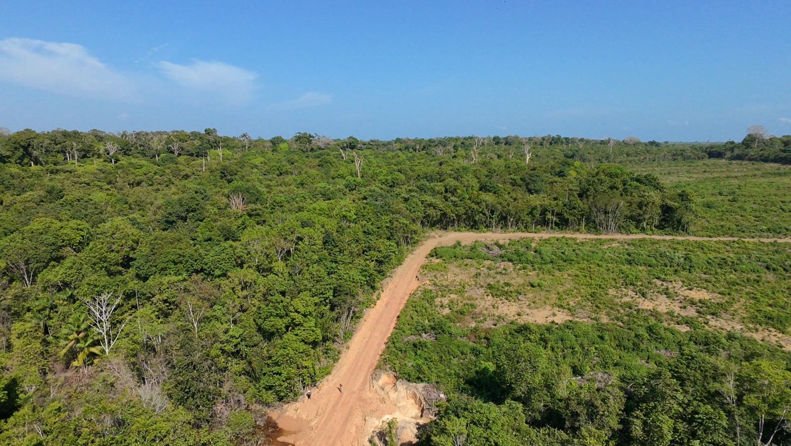 Een luchtfoto toont een nieuw vrijgemaakte onverharde weg die door het Amazone-regenwoud loopt, vlakbij het Potássio Autazes-project in Autazes, in de staat Amazonas. Afbeelding door Filipe Gabriël Mura.